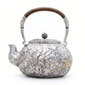Pure 999 Fine Silver Handcrafted Silver Teapot with Intricate Floral Relief and Rattan-Wrapped Handle - Handicraft